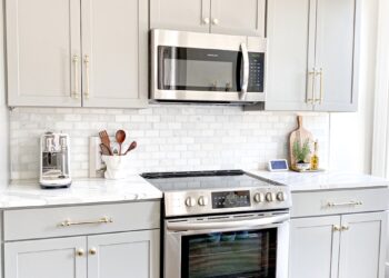white microwave oven on white wooden cabinet