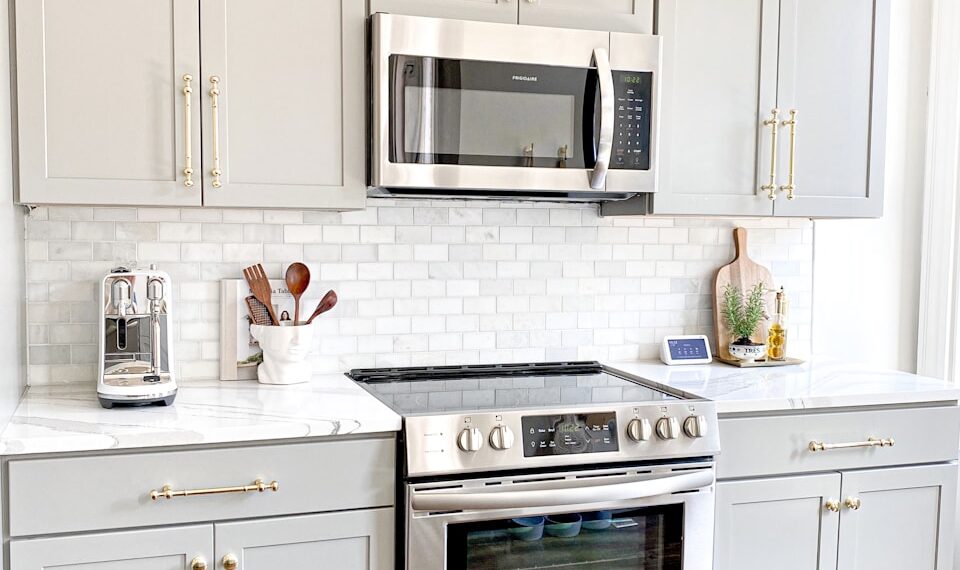 white microwave oven on white wooden cabinet