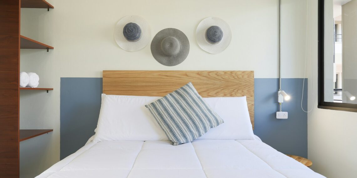 white bed with throw pillows