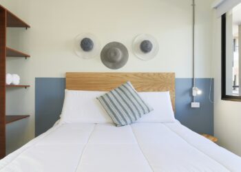 white bed with throw pillows