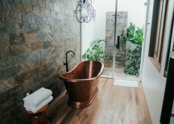 brown plastic bucket near white framed glass door