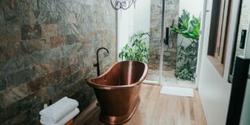 brown plastic bucket near white framed glass door
