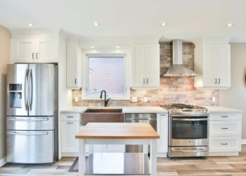 white top mount refrigerator beside white wooden kitchen cabinet