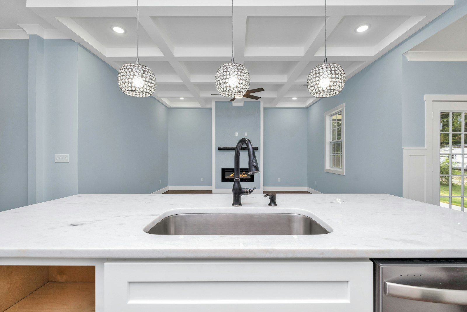 a kitchen with a sink and a chandelier