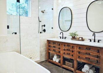 white ceramic bathtub near brown wooden cabinet
