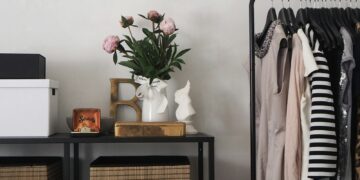 pink flowers in white vase on table