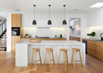 brown wooden seat beside white wooden table