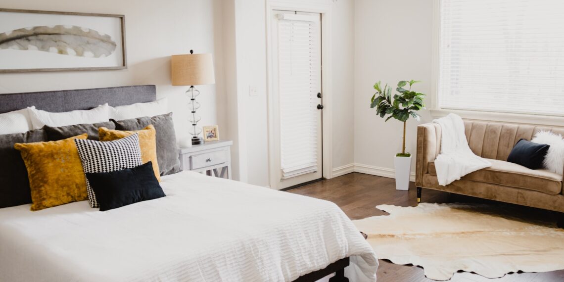white bed linen near white wooden door