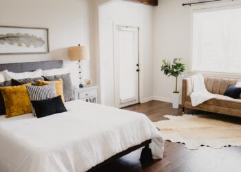 white bed linen near white wooden door