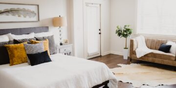 white bed linen near white wooden door