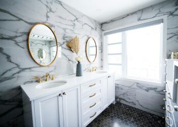 a bathroom with two sinks and a large mirror