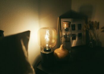 clear glass lamp on black wooden table