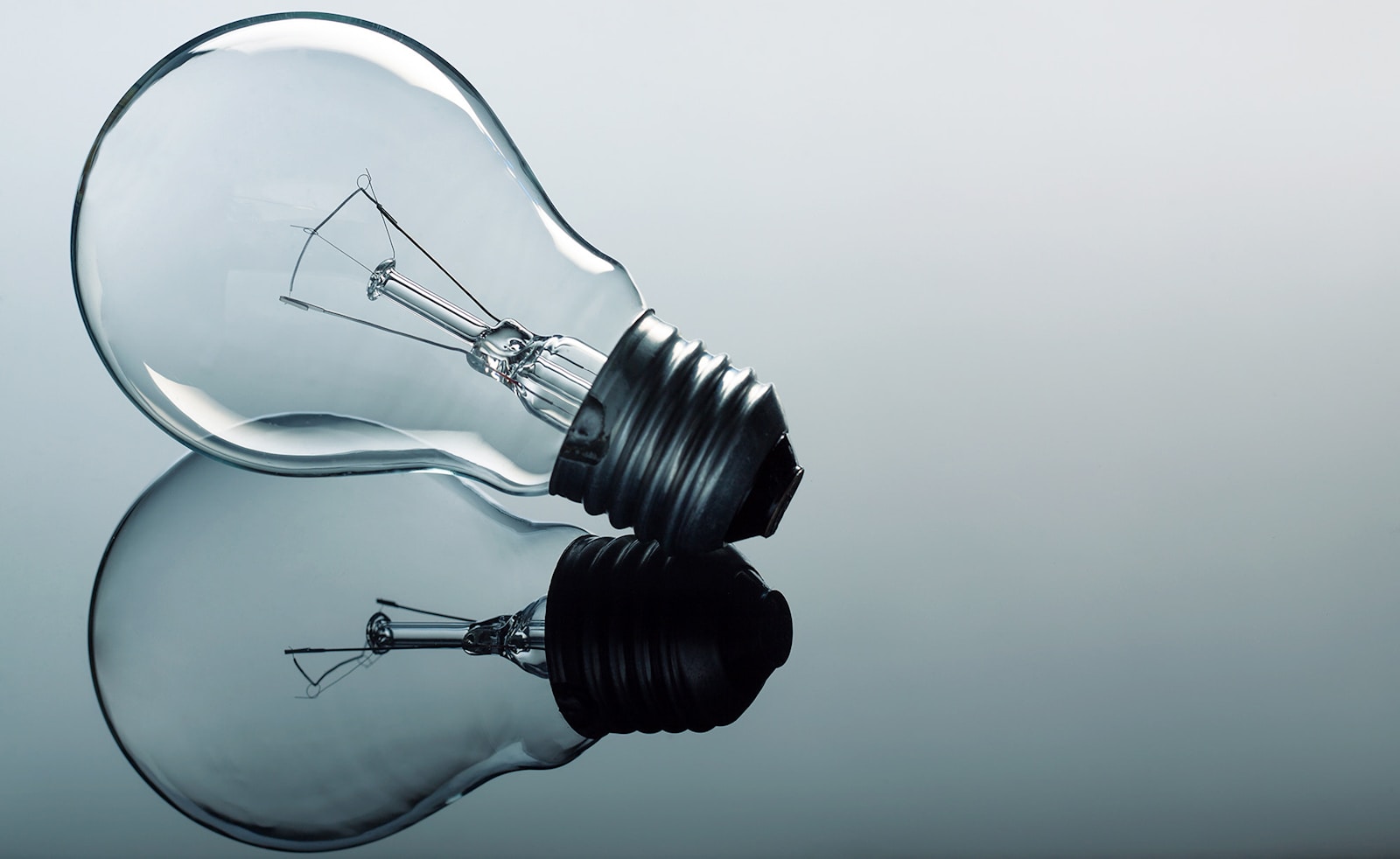 a light bulb sitting on top of a reflective surface